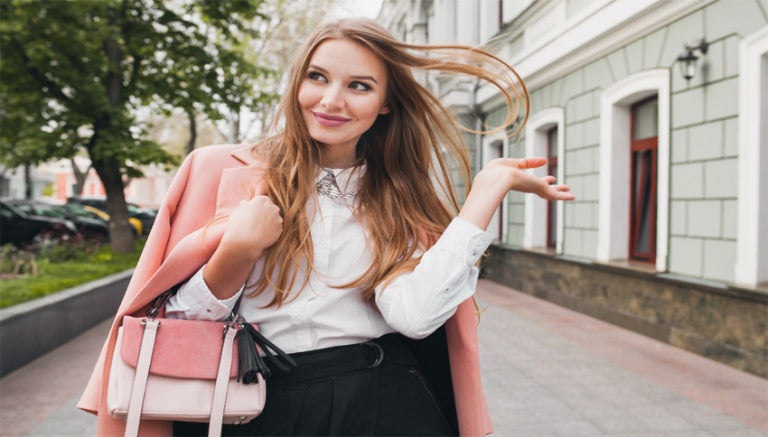 beautiful lady having skincare goods in purse