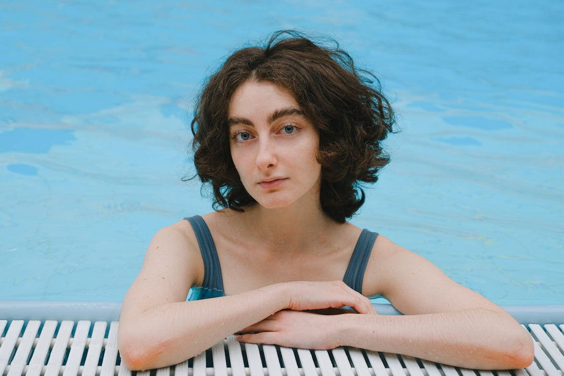 girl in swimming pool after applying cooling ice face mask 